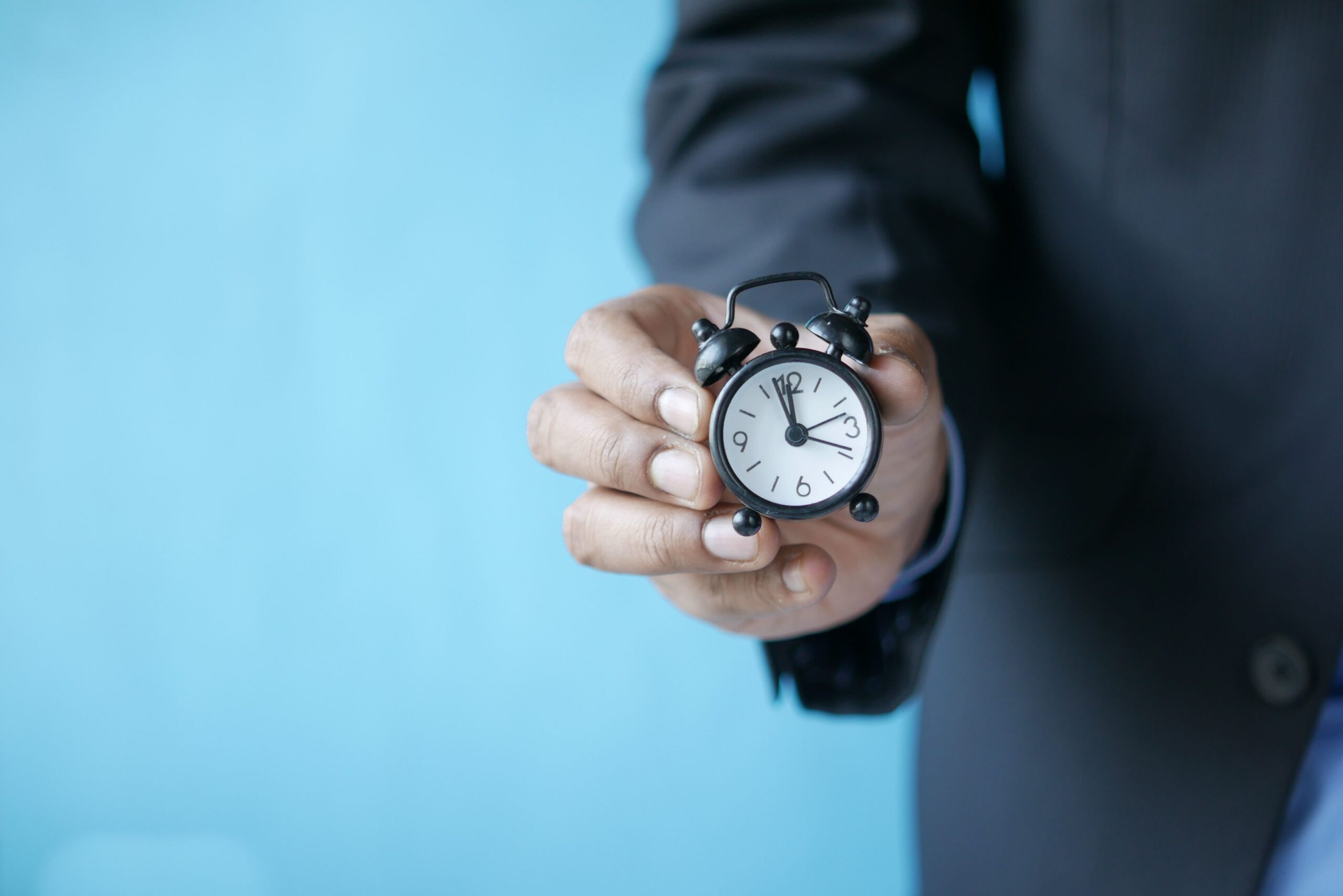 Person holding an alarm clock, symbolizing the DTSA statute of limitations deadline for trade secret claims