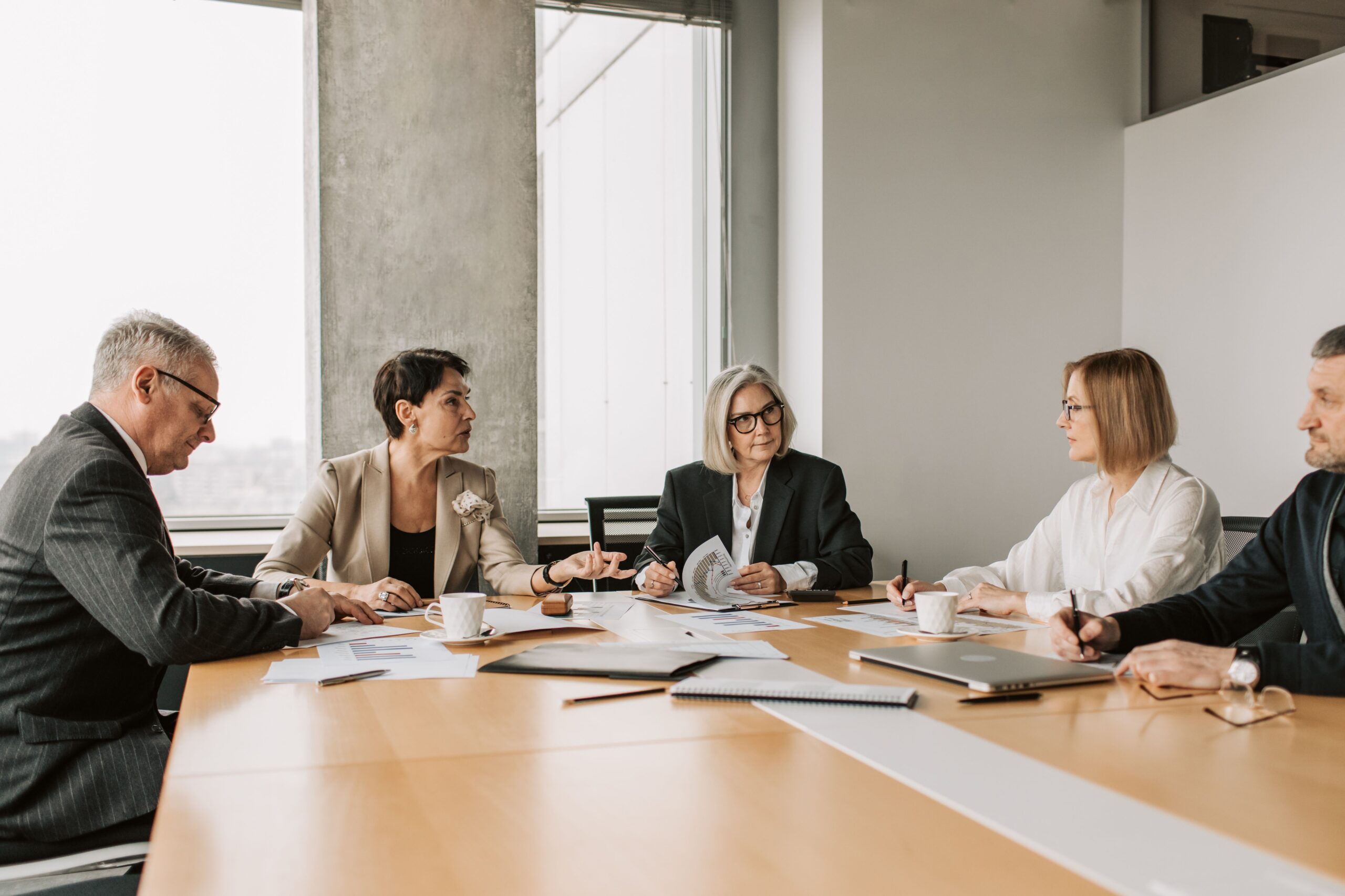 Business professionals in a conference room meeting, representing the process of selecting a mediator for IP disputes